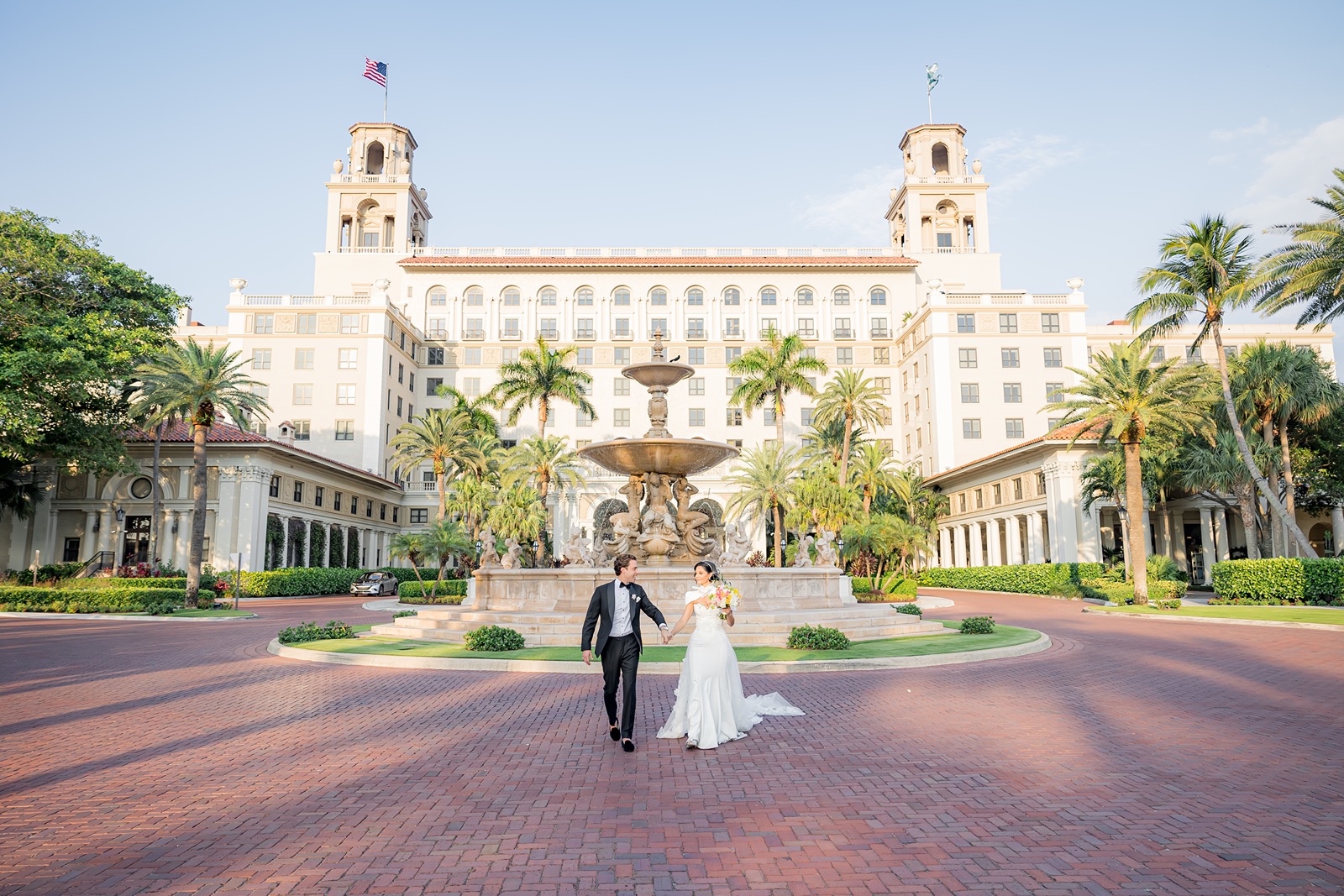 Bride and groom in front of the iconic Breakers Hotel in Palm Beach