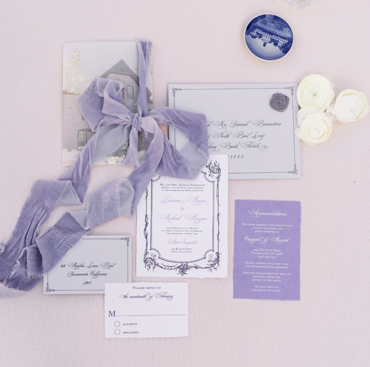 Soft lavender and gray invitation suite tied with velvet ribbon, featuring delicate typography and coordinated inserts, a custom wedding invitation design with a romantic, vintage feel.