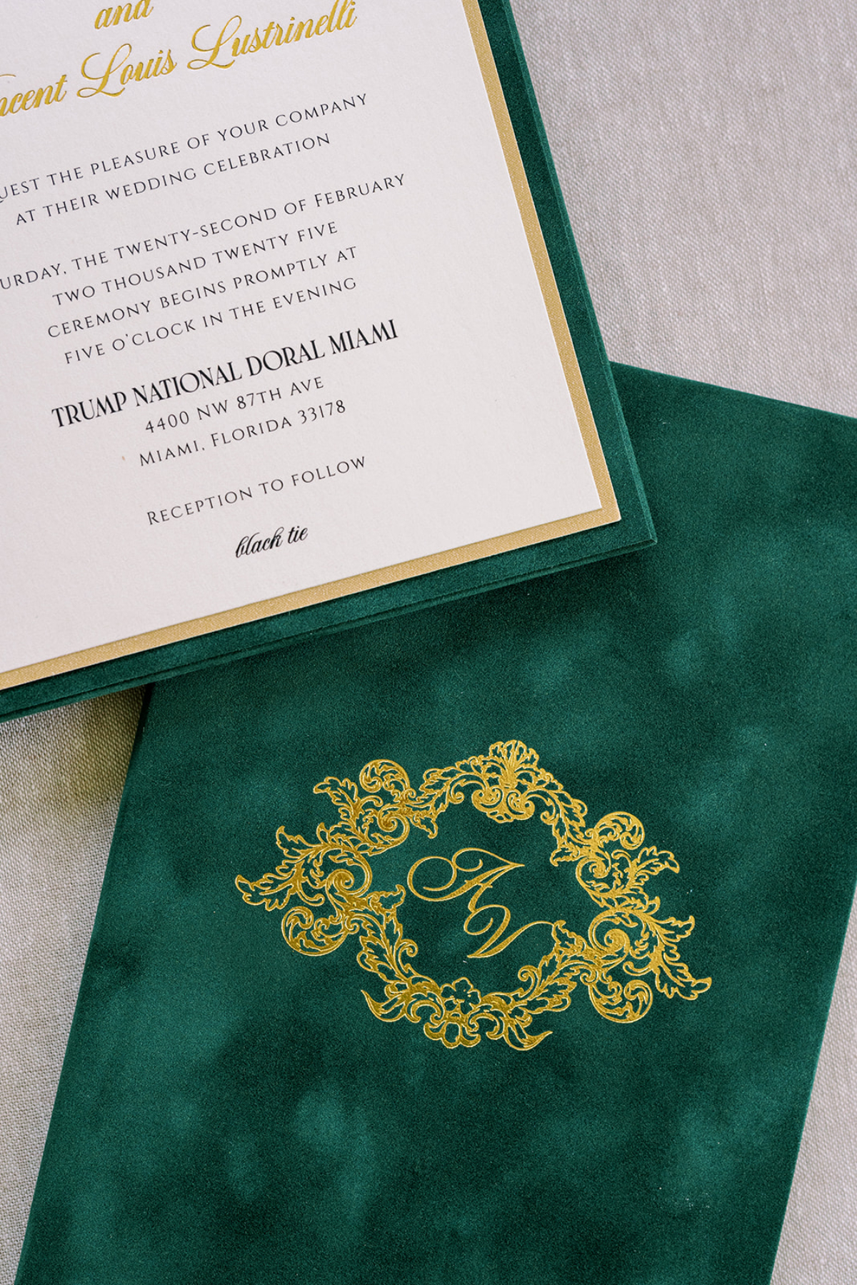 Luxurious emerald velvet envelope with gold foil monogram and matching bordered card, a rich custom wedding invitation design featuring deep jewel tones and elegant typography.